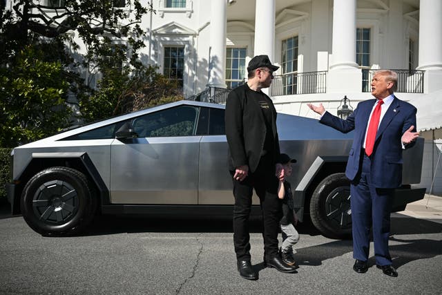 <p>Elon Musk and Donald Trump pose in front of a Cybertruck</p>