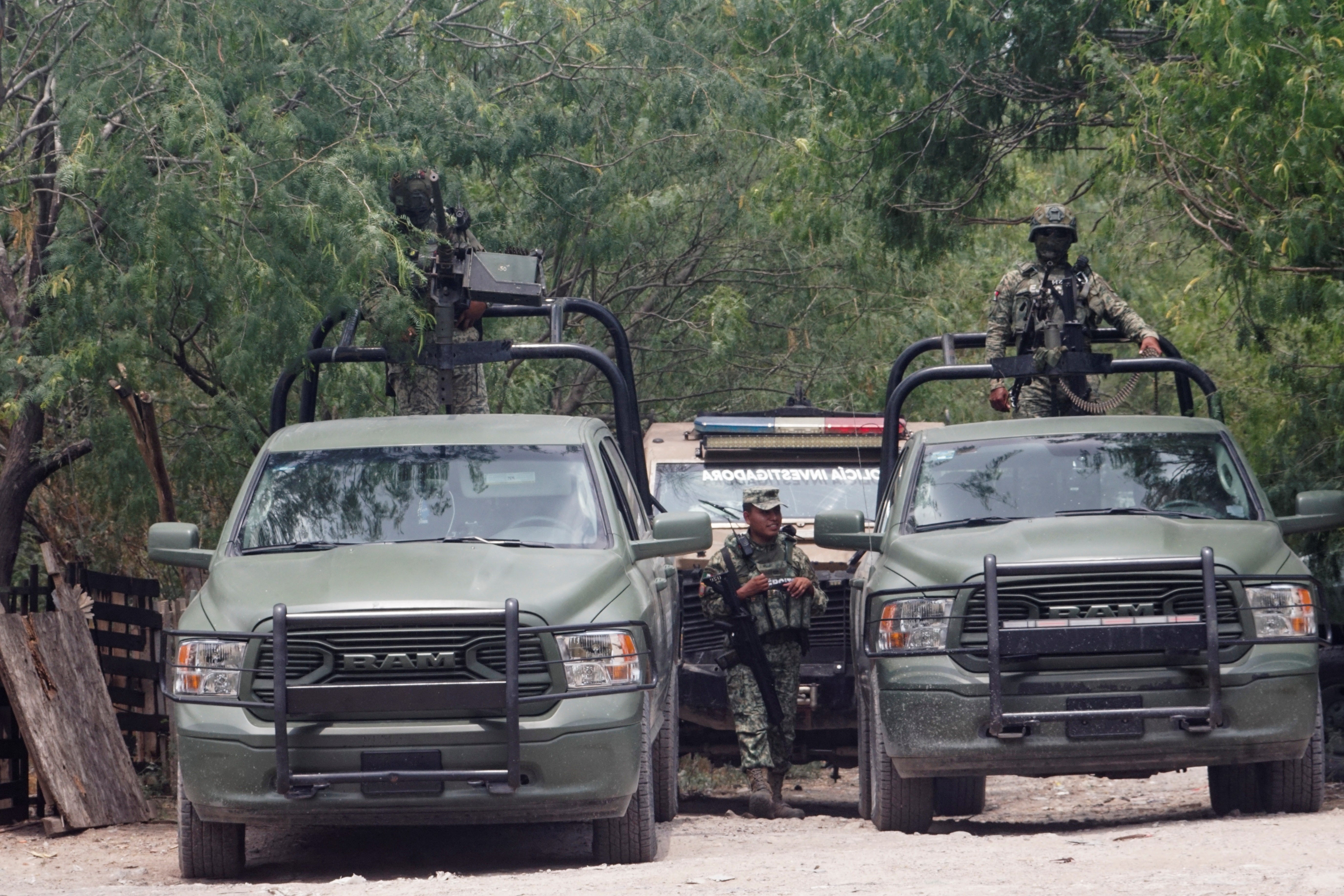 Mexican Army members stand guard at the scene where, according to Mexican authorities, the members of the musical group Grupo Fugitivo were found dead, in Reynosa, Mexico