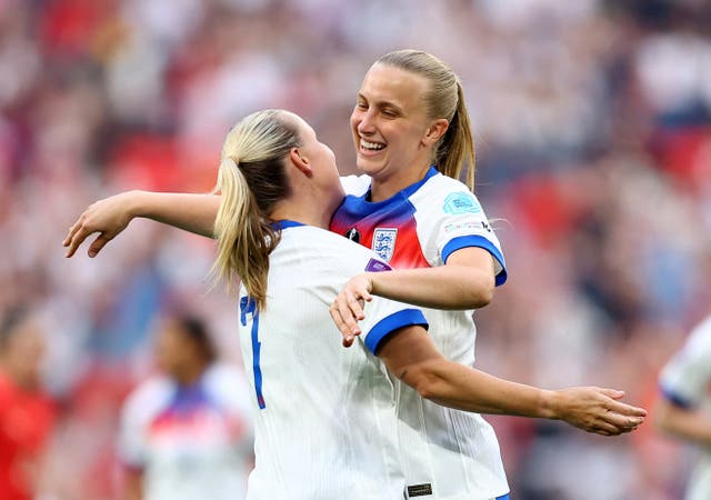 <p>Aggie Beever-Jones, right, celebrates the first goal of her hat-trick in north London</p>