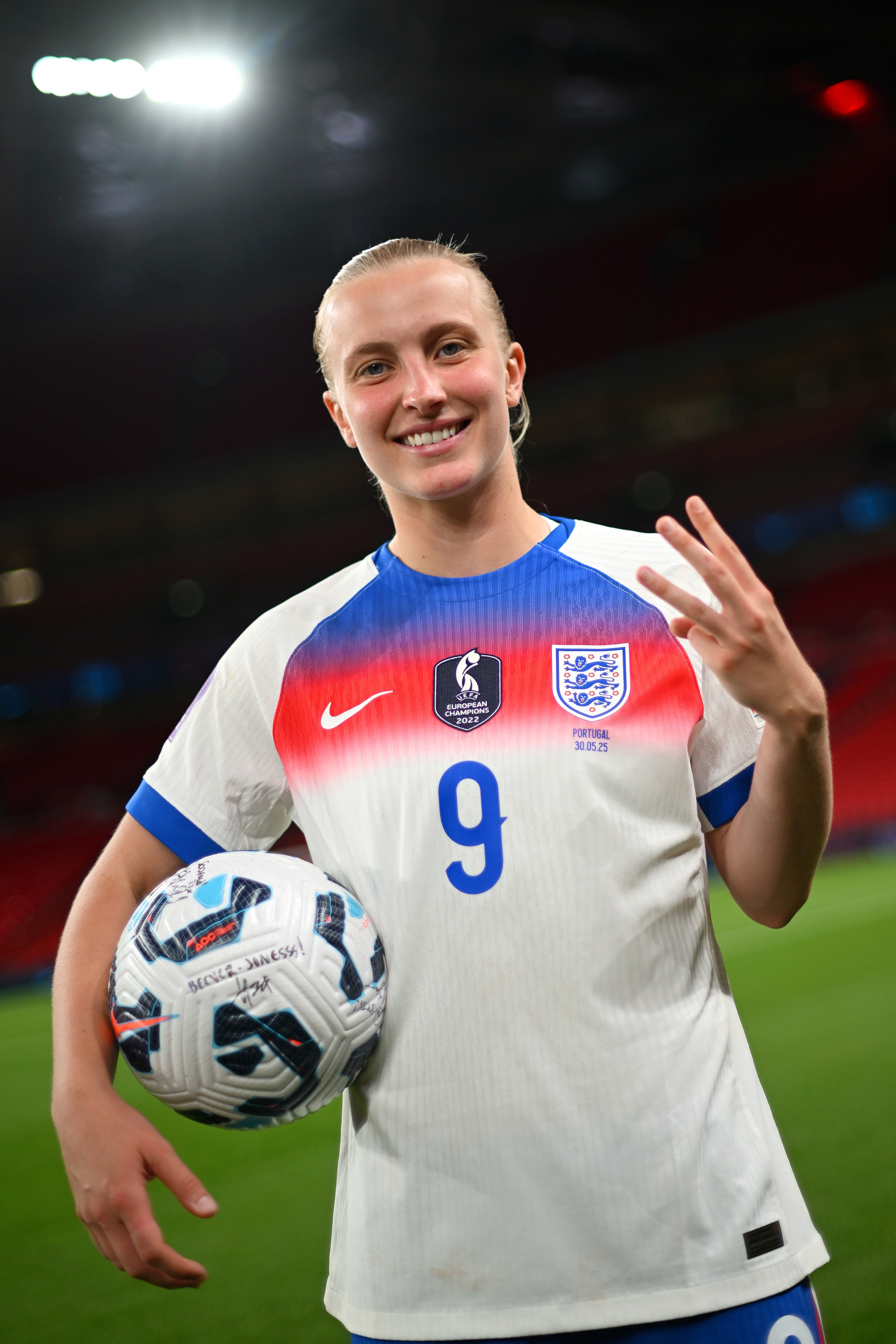 Aggie Beever-Jones celebrates with the match ball after scoring her hat-trick for England