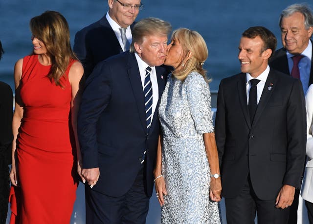 <p>Brigitte Macron, first lady of France, kisses President Donald Trump on the cheek</p>