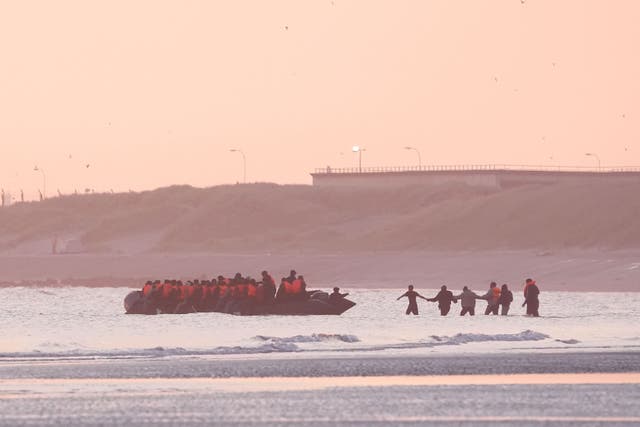 People thought to be migrants board a small boat leaving the beach at Gravelines, France (Gareth Fuller/PA)