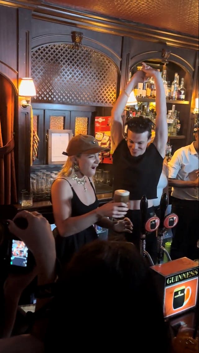 <p>Florence Pugh and Yungblud serving pints to customers at The Devonshire in Piccadilly, as the pair celebrated the launch of singer's new single 'Zombie' whose music video stars Pugh</p>