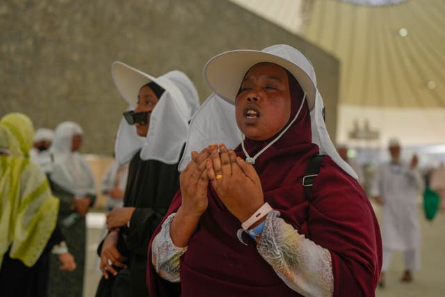 <p> A pilgrim offer prayers after she cast stones at a pillar in the symbolic stoning of the devil, during the annual Hajj pilgrimage in Mina, near the holy city of Mecca, Saudi Arabia, Tuesday, June 18, 2024</p>