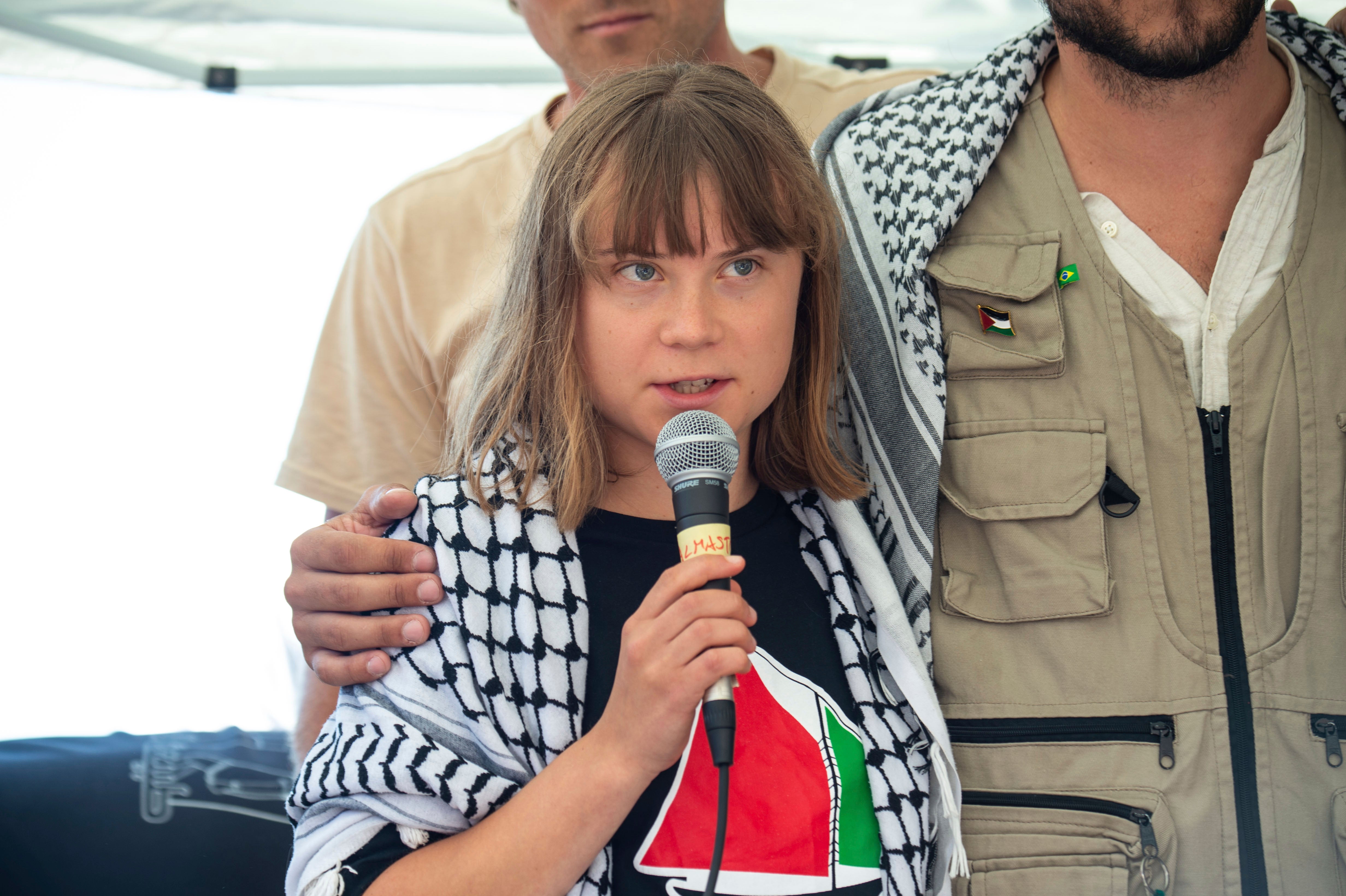 Climate activist Greta Thunberg with other activists from a human rights organisation in Catania, Italy