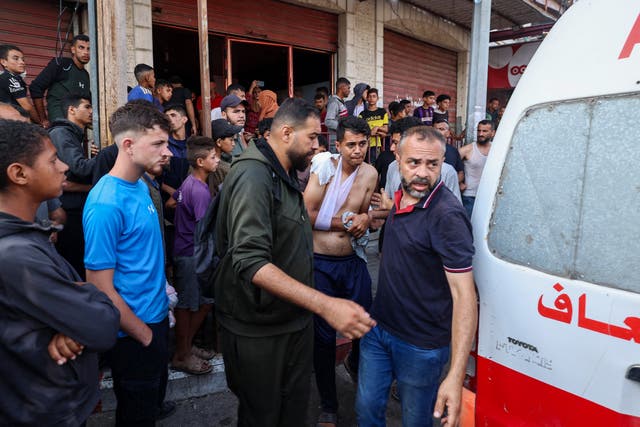<p>Palestinians injured by a drone strike on their way to a food distribution centre are taken to hospital on Sunday</p>