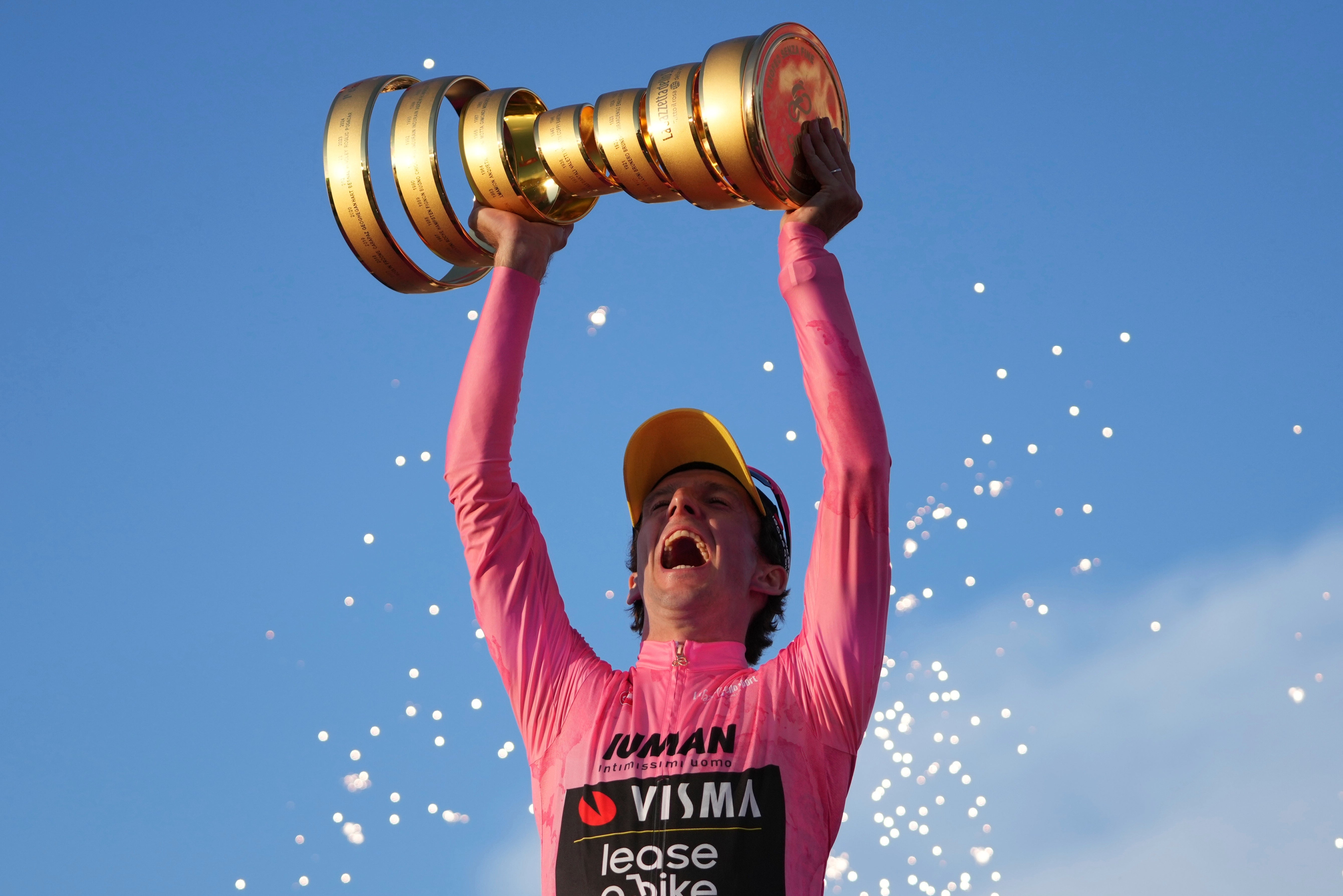 Yates lifts the trophy after winning the Giro d’Italia in Rome (Alessandra Tarantino/AP)