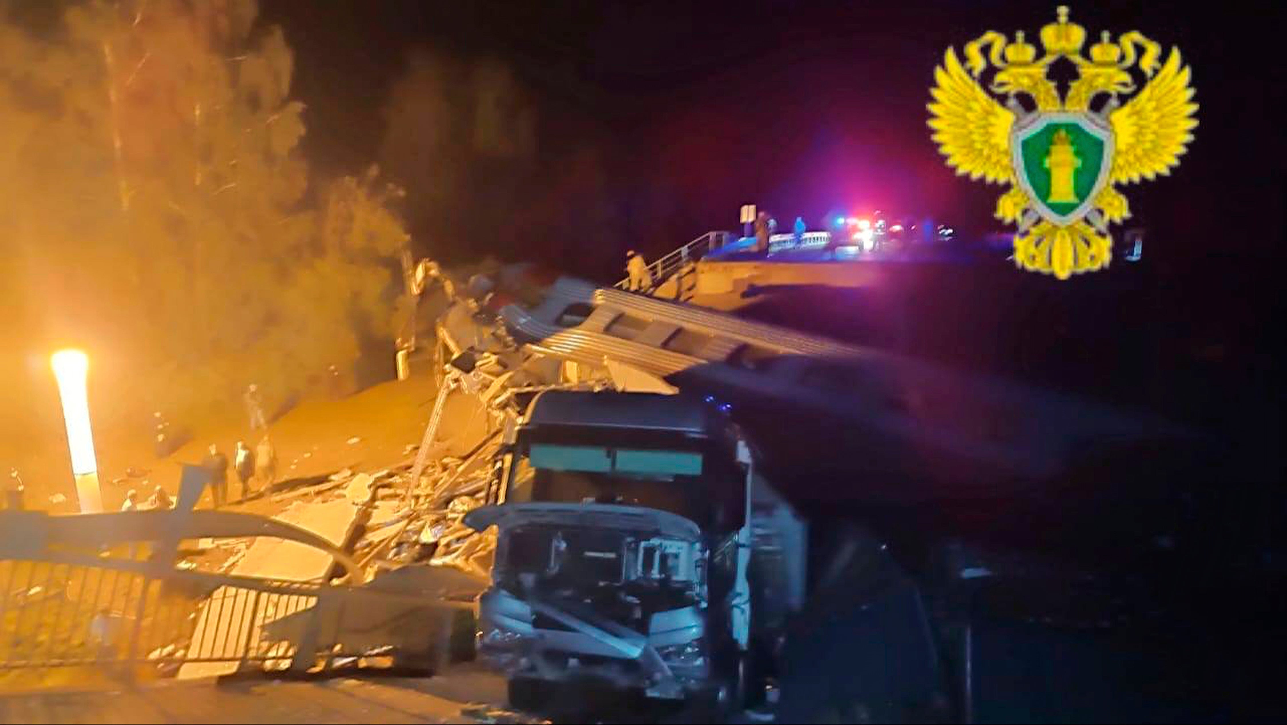 In this photo released by Russian officials, emergency employees work at a damaged bridge in Russia's Bryansk region, which borders Ukraine