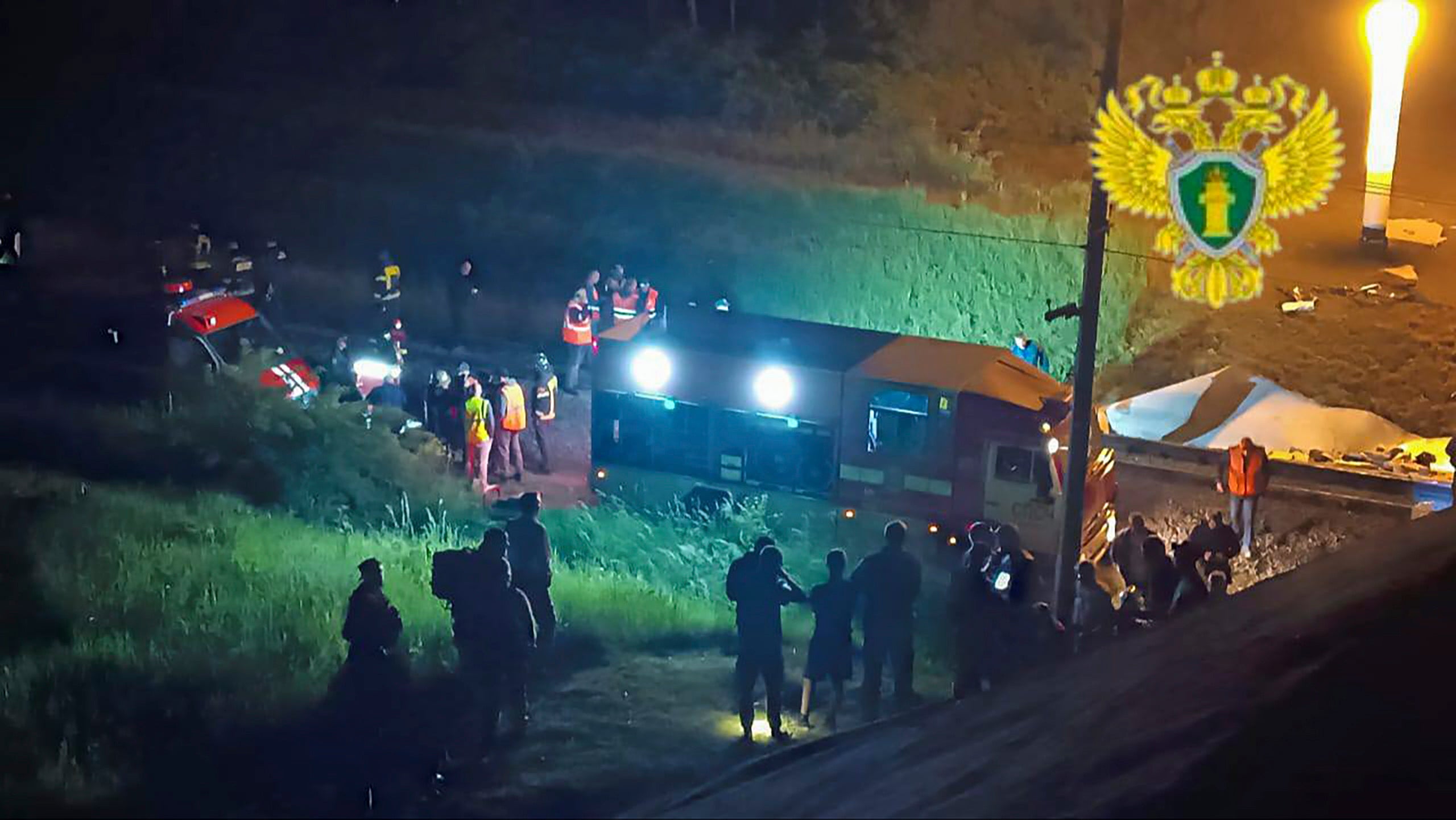 In a photo released by Russian officials, Russian rescuers are seen working at the site after a bridge collapsed on a passenger train in the Vygonichsky district, Bryansk region, on Sunday