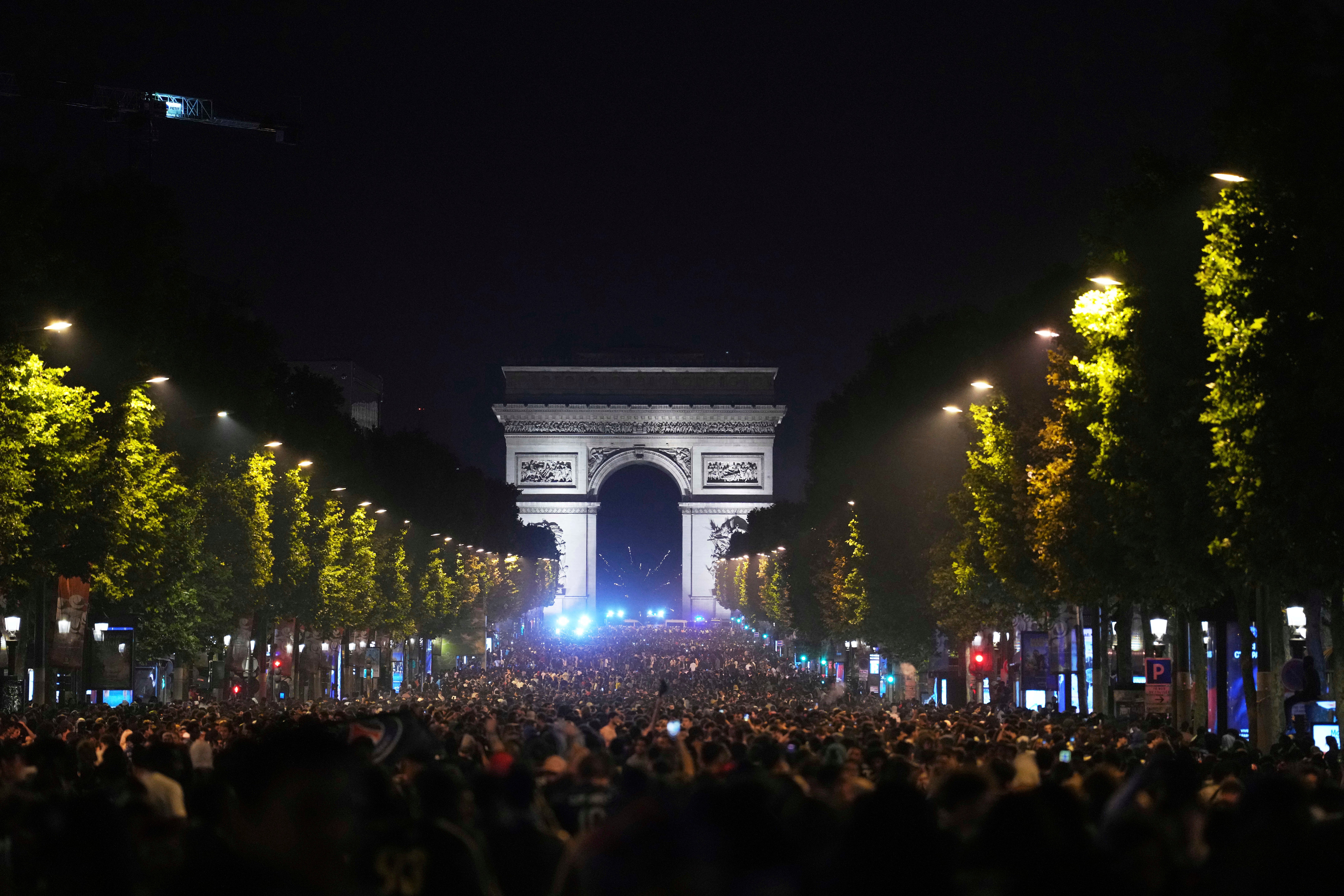 Os fãs de Paris Saint-Germain comemoram a vitória da equipe na Avenida Champs-Elysees após a final da Liga dos Campeões entre Paris Saint-Germain e Inter Milan