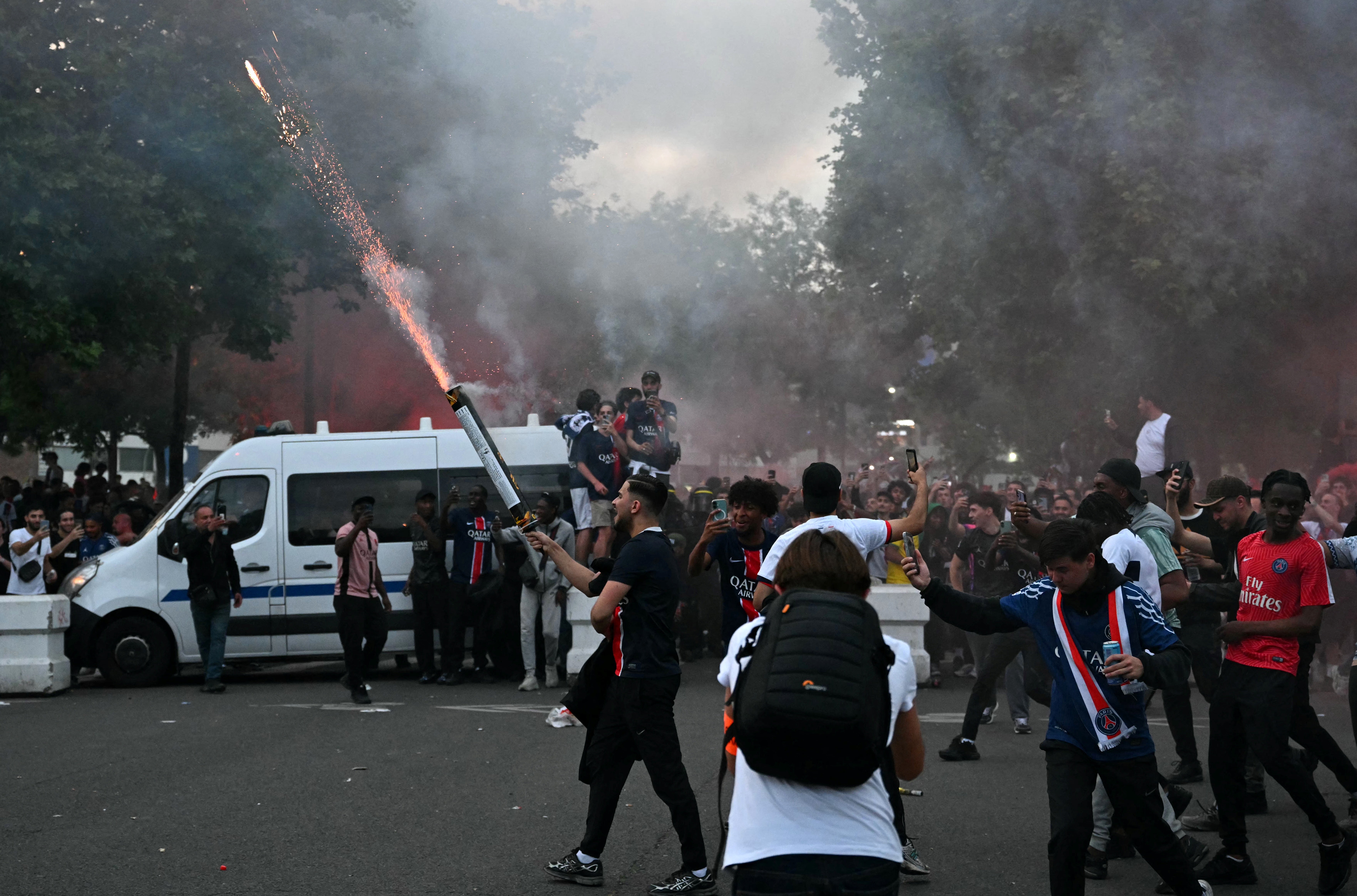 <p>Paris Saint-Germain supporters react with fireworks after their team's second goal as they watch the UEFA Champions League final football match between Paris Saint-Germain (PSG) and Inter Milan near Parc des Princes Stadium in Paris</p>