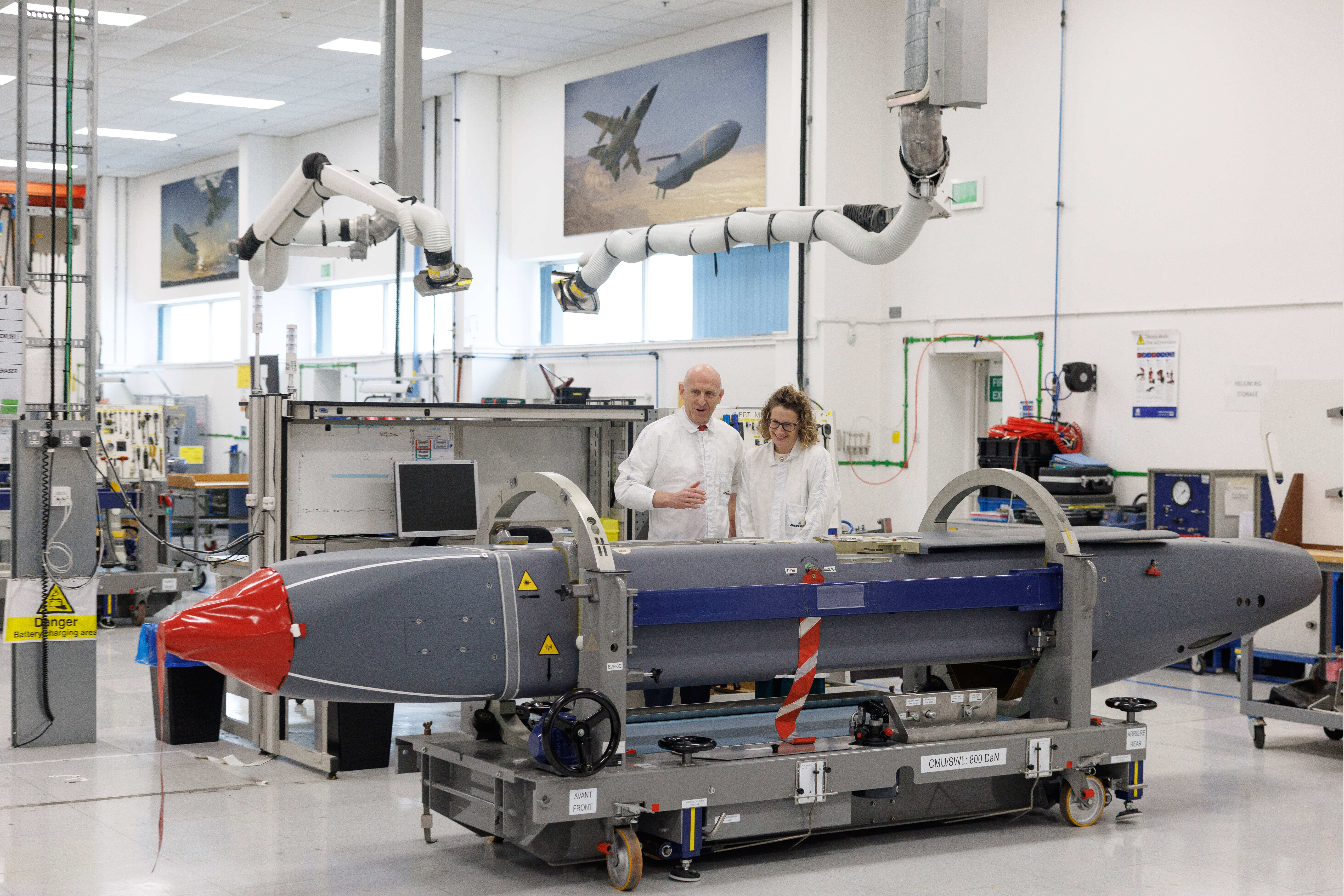 Louise Holmes, MBDA UK Deputy Managing Director, shows Britain's Defence Secretary John Healey, left, a storm shadow missile on an assembly line at the MBDA Storm Shadow factory in Stevenage