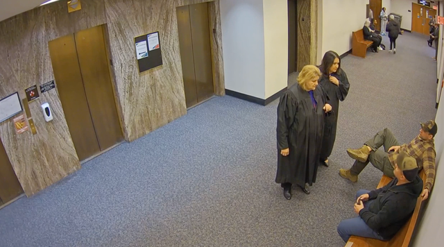 <p>Judge Dugan can be seen speaking with federal agents inside the courthouse to make an immigration arrest on April 18. A criminal complaint accuses the judge of ‘confrontational, angry demeanor’</p>