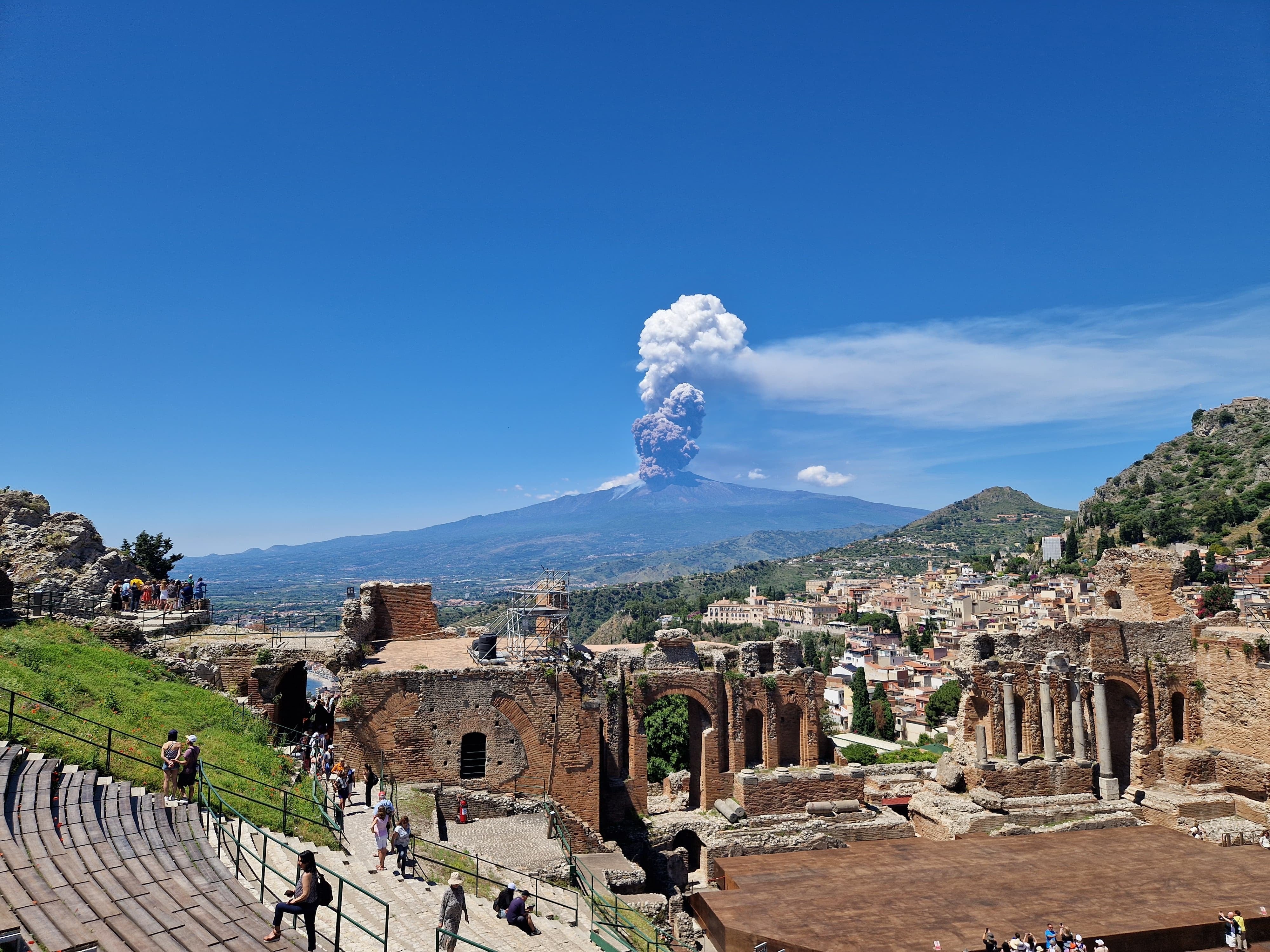 Mount Etna is seen erupting, from the Ancient Theatre of Taormina