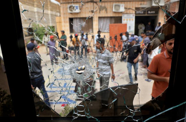 <p>A broken glass window inside the jail after dozens of prisoners escaped</p>
