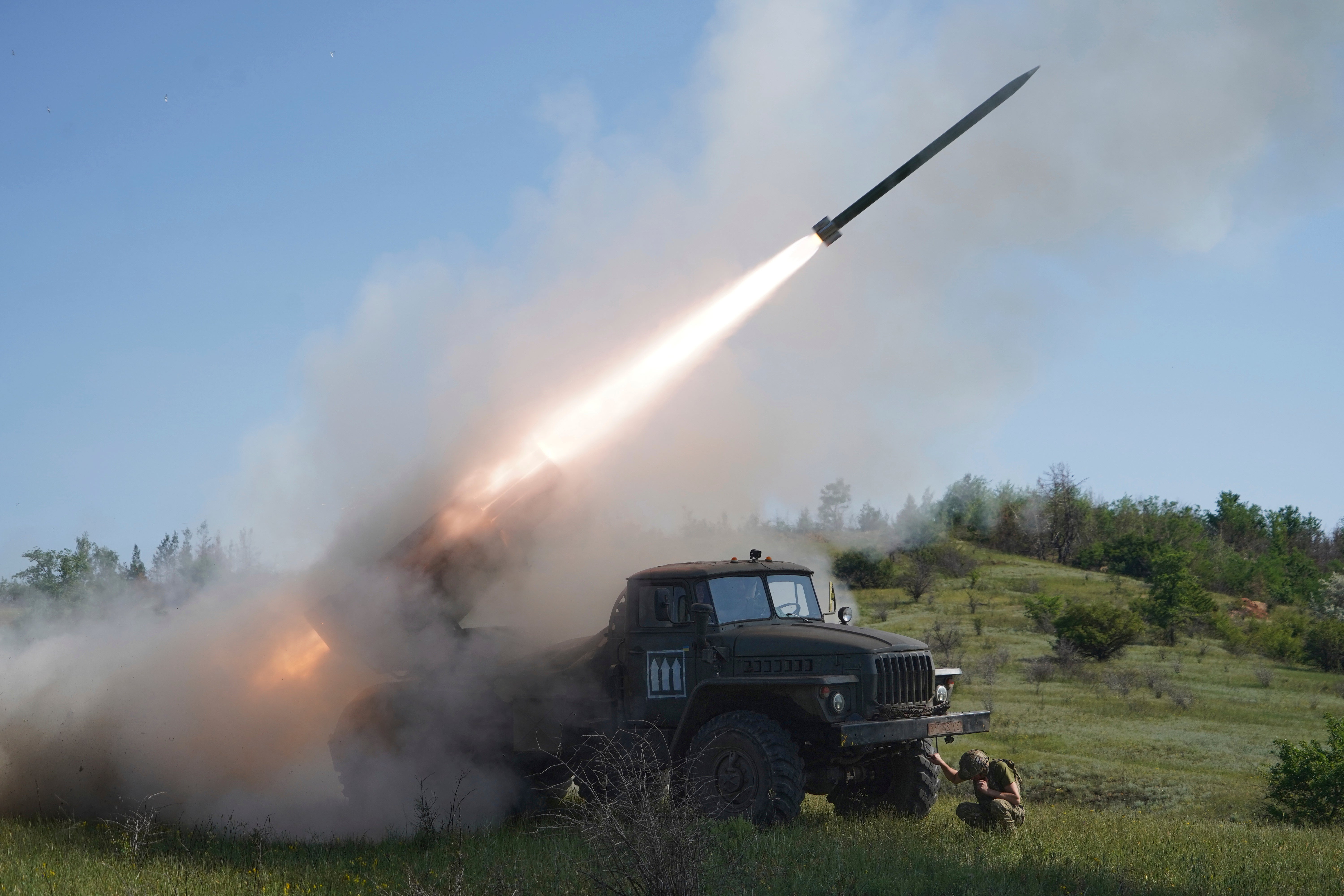 Soldiers of Ukraine's 30th Separate Mechanized Brigade fire a Grad multiple rocket launcher towards Russian positions at the frontline in Donetsk region on June 3