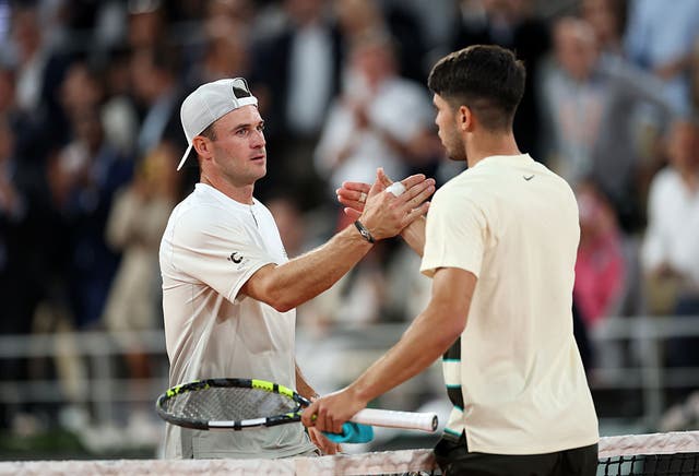 <p>Carlos Alcaraz shakes hands with Tommy Paul after returning to the French Open quarter-finals</p>