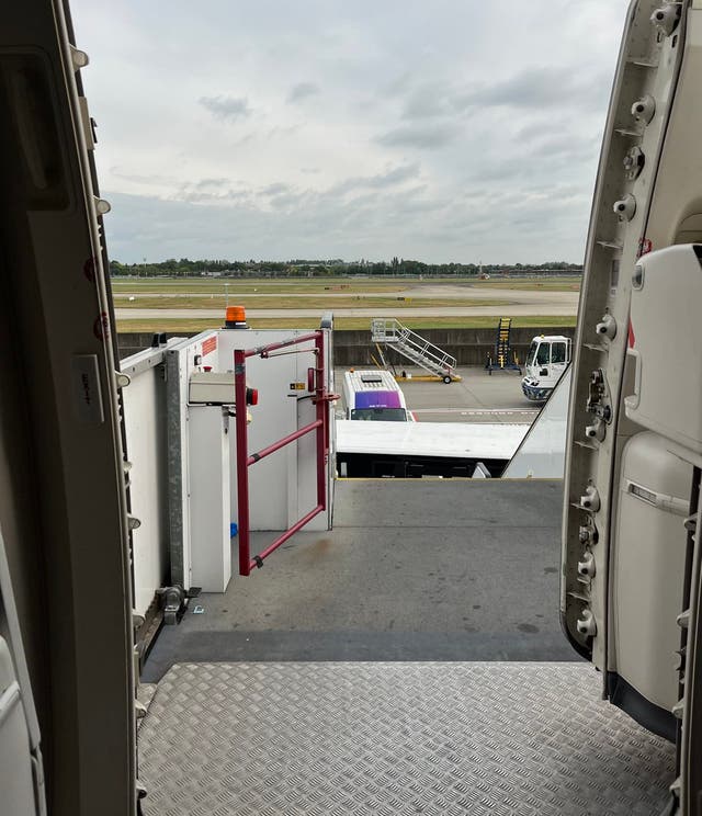 <p>What now? Steps attached to flight BA12, a Boeing 777 at a remote stand at London Heathrow airport</p>