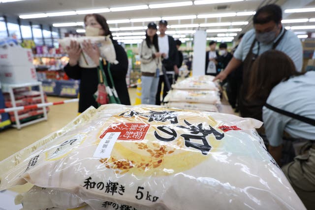 <p>Customers buy stockpiled rice which went on sale at a store in the city of Sendai, Miyagi prefecture</p>