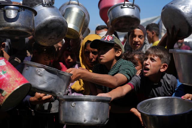 <p>Desperate Palestinians seek food at a distribution centre in Khan Younis, in the southern Gaza Strip</p>