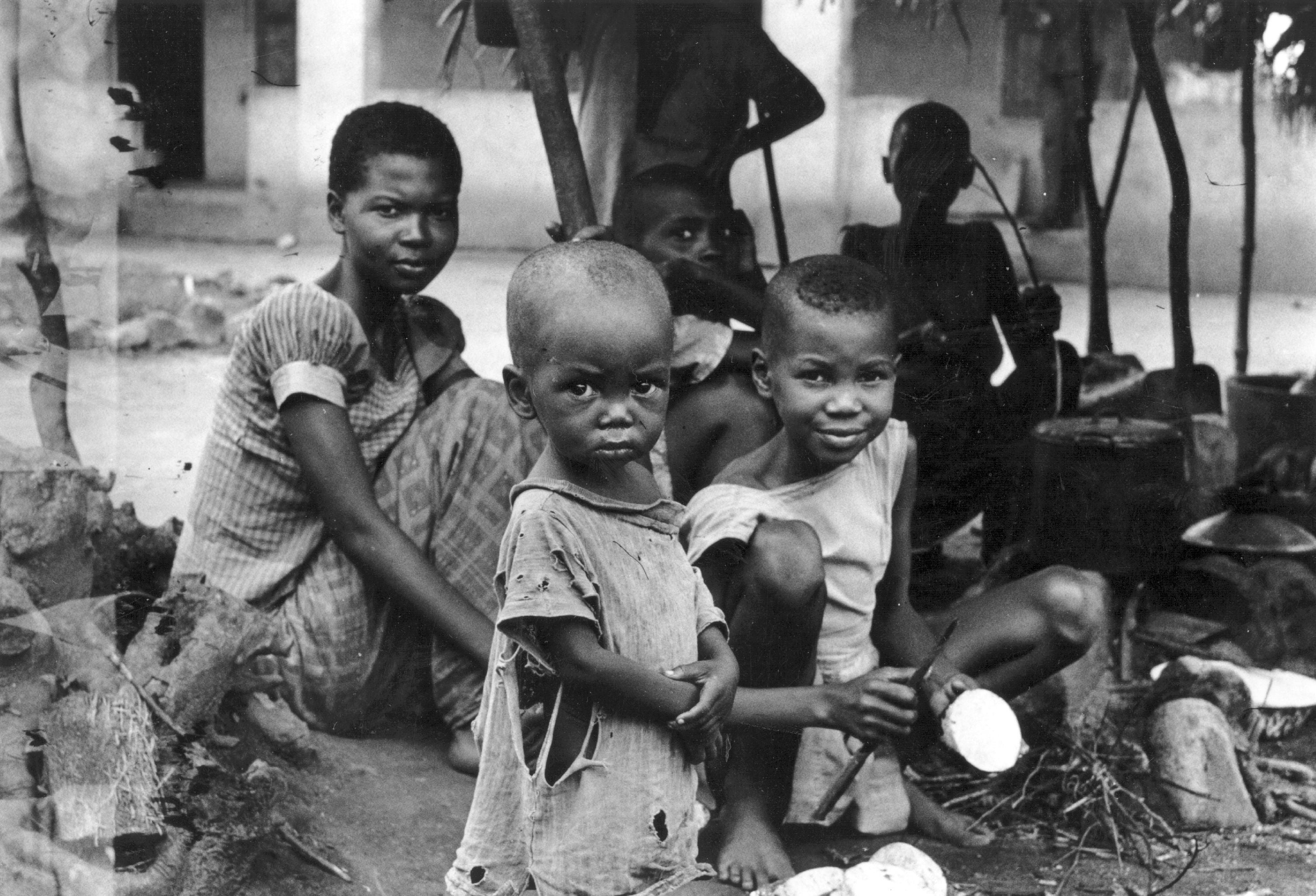 A starving family during the Biafran war in 1968 wait for food
