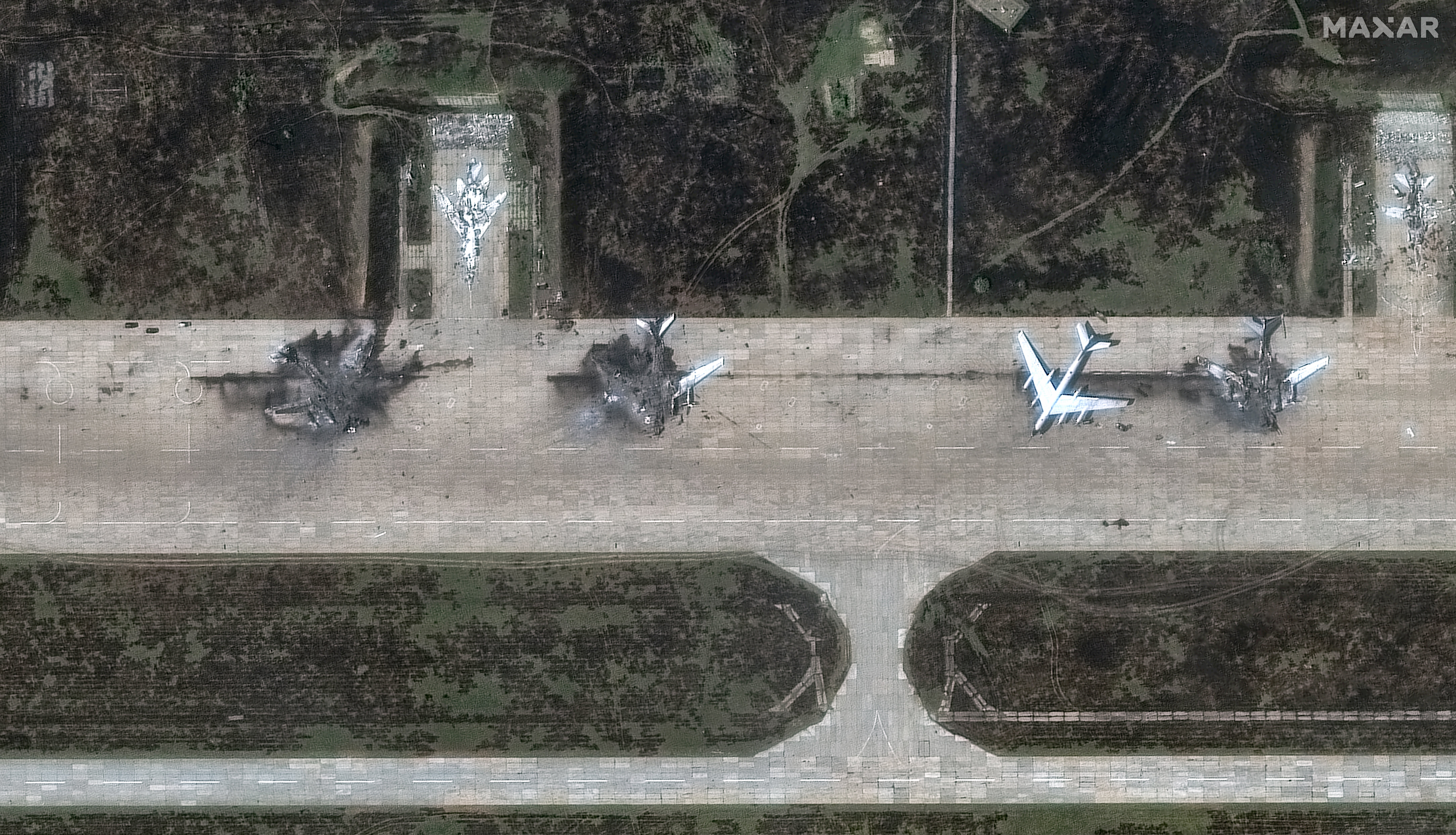 A handout satellite image made available by Maxar Technologies shows Tupolev Tu-95 aircrafts destroyed following a series of Ukrainian drone strikes at the Belaya Airbase
