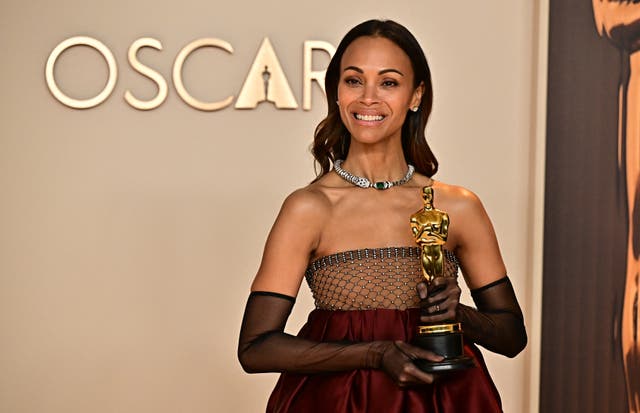 <p>Zoe Saldana poses in the press room with the Oscar for Best Actress in a Supporting Role for "Emilia Perez" during the 97th Annual Academy Awards at the Dolby Theatre</p>