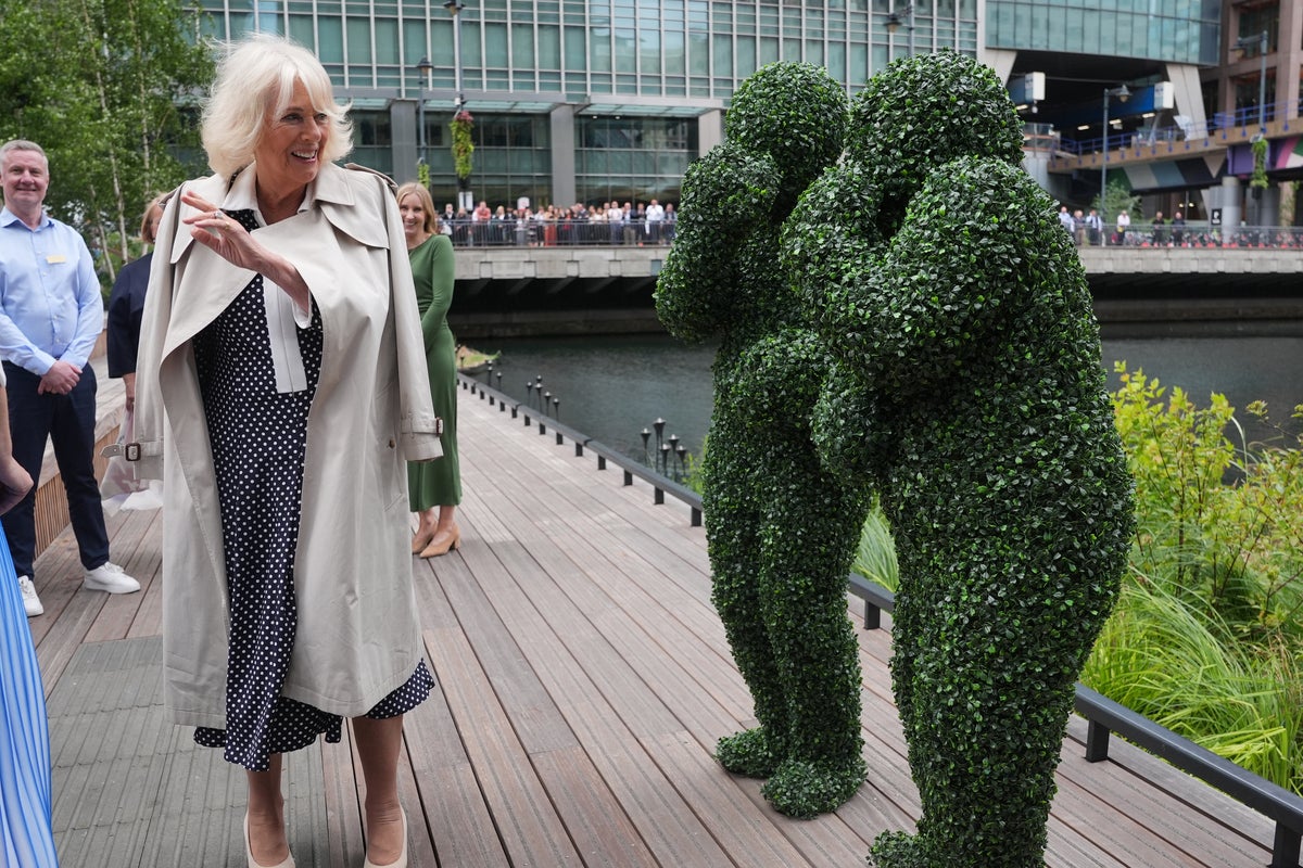 Bizarre moment Queen Camilla meets people dressed as bushes