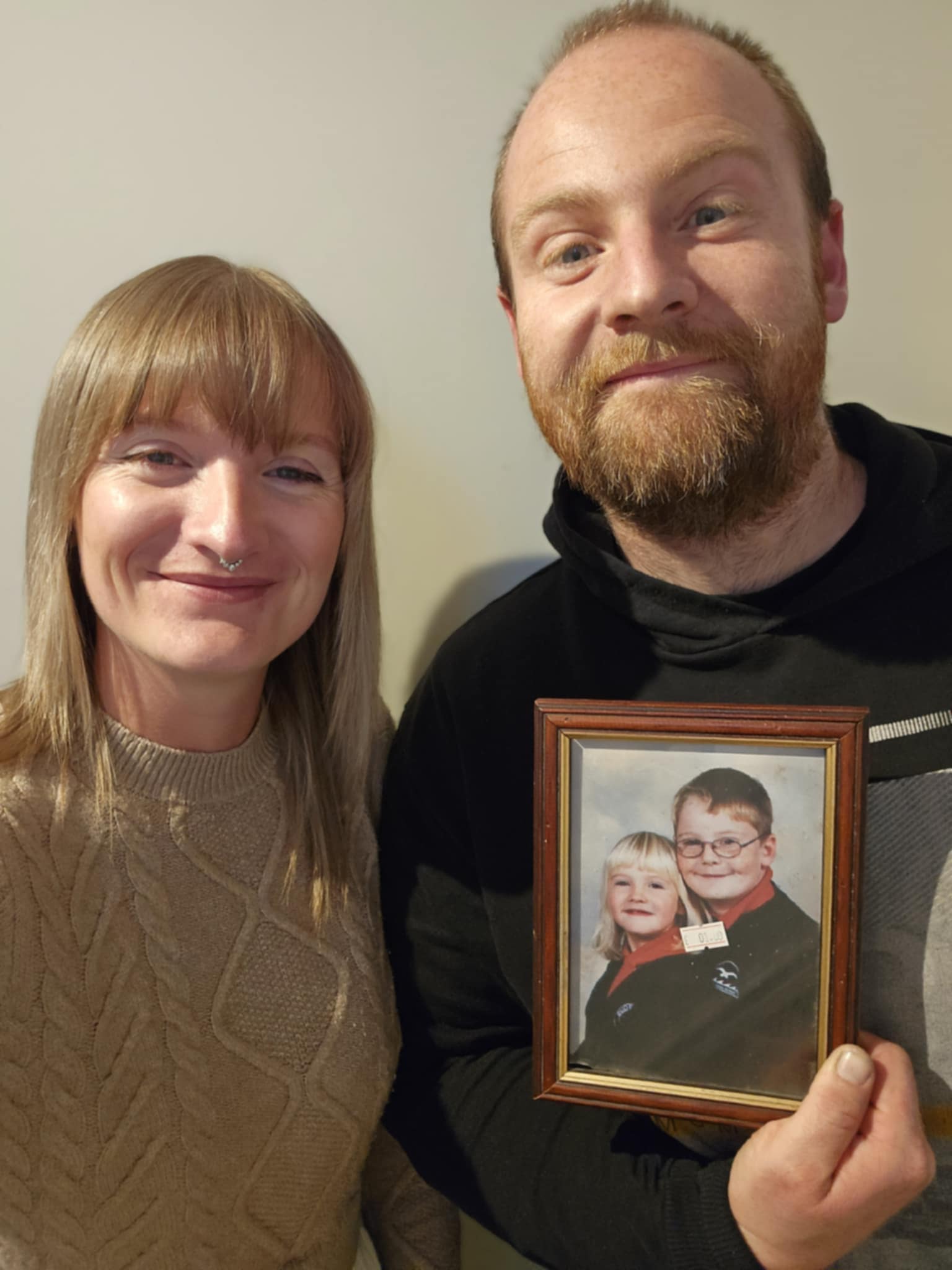 Jade and Chris Kirkum now with the photo of them as children at school (Family handout/PA)