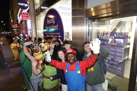 <p>Nintendo fans lined up outside of Currys in London’s Oxford Street, which opened at midnight</p>