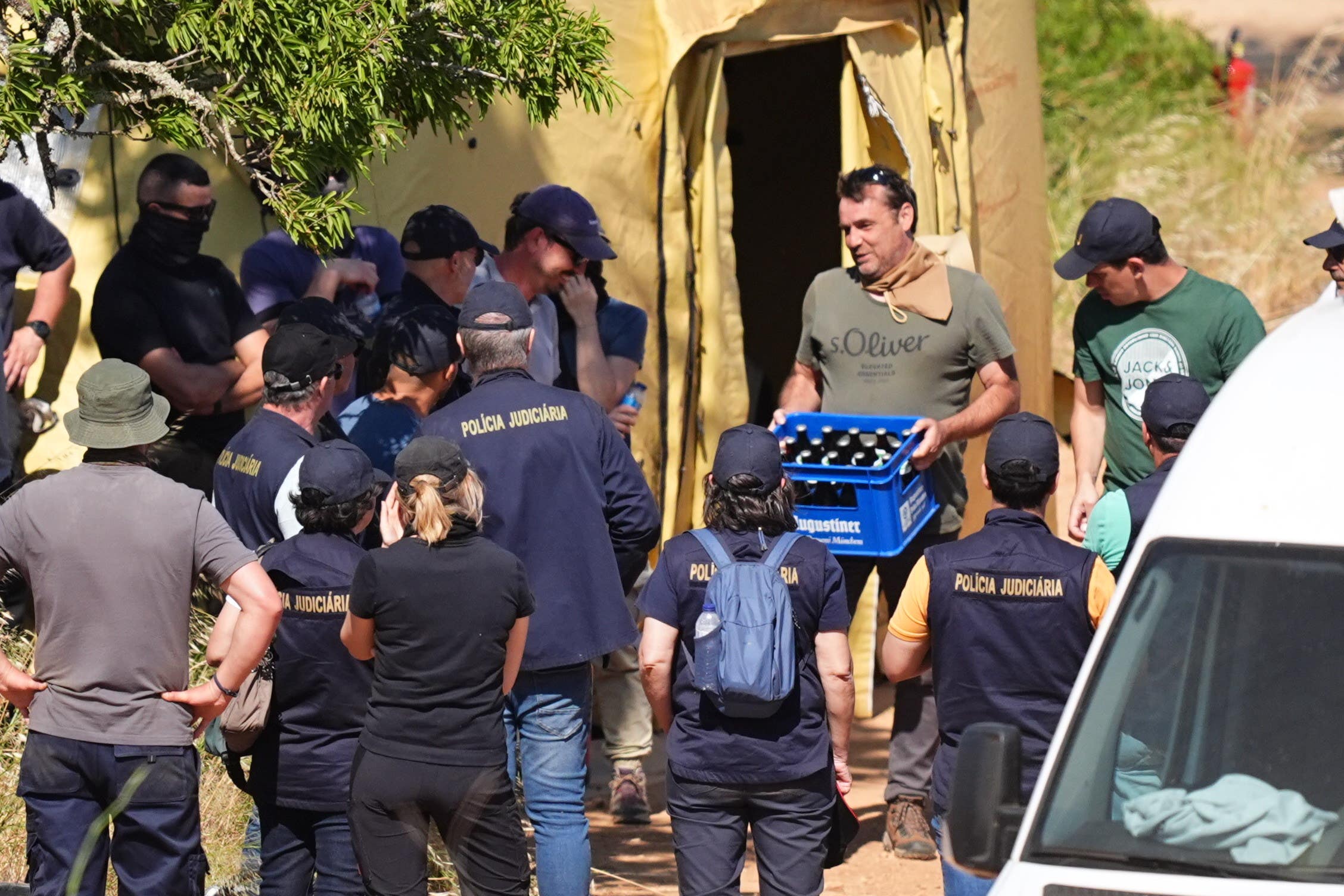 A crate of drink is produced by members of the search teams (James Manning/PA)