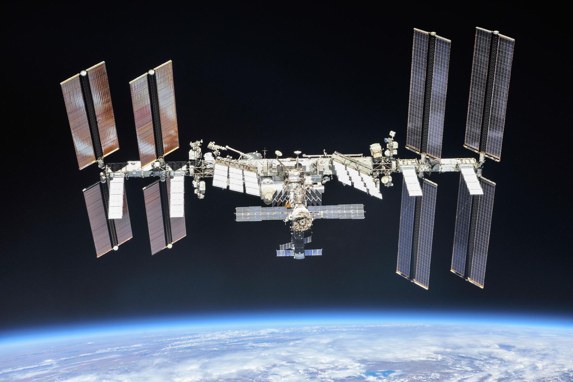 The International Space Station is seen in orbit above Earth. The space station first launched in 1998. There are seven crew members on the space station right now