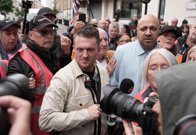 <p>Tommy Robinson (centre), whose real name is Stephen Yaxley-Lennon outside Westminster Magistrates' Court, central London, where he is charged with harassment of two journalists between August 5 and 7 2024</p>