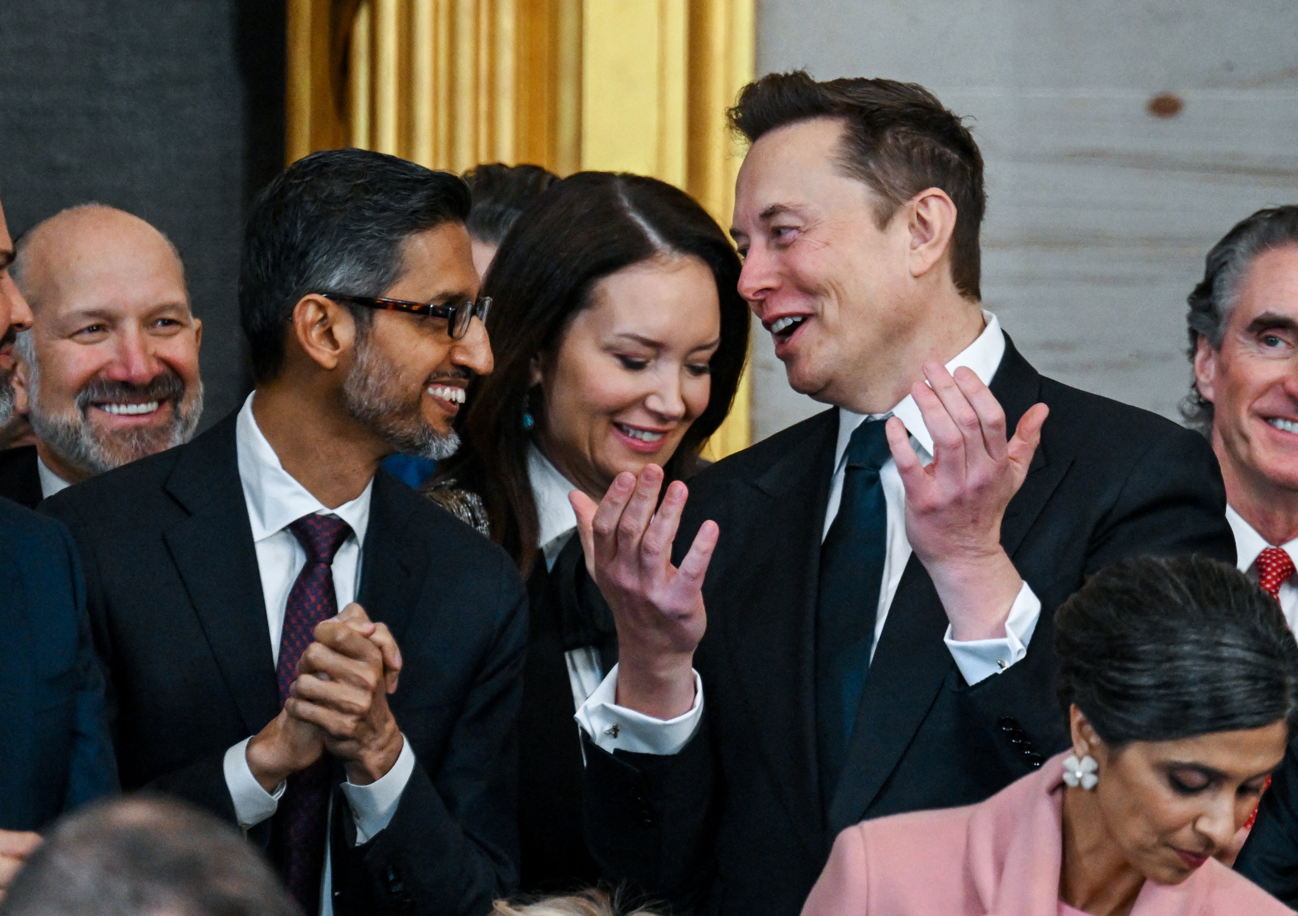 Google CEO Sundar Pichai (front left) stands with Elon Musk during the second inauguration of Trump on January 20, 2025
