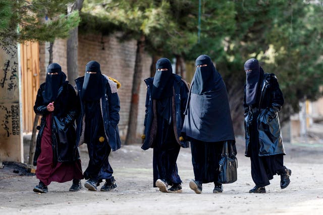 <p>Afghan women walk along a street on the outskirts of Kabul</p>