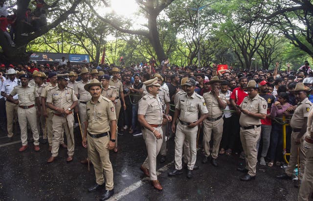 <p>Police stand in front of crowds as fans gather outside the M Chinnaswamy Stadium to celebrate Royal Challengers Bengaluru winning the Indian Premier League (IPL), in Bengaluru</p>