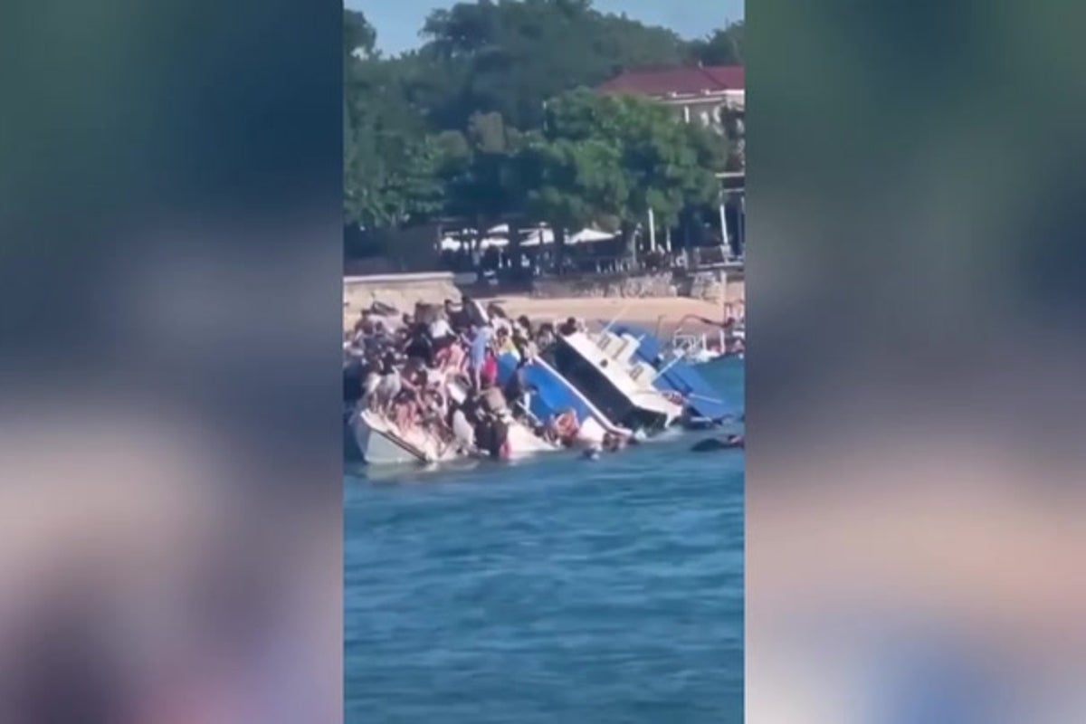 Watch: Terrified passengers cling on as boat carrying 89 tourists sinks in Bali