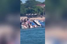 Watch: Terrified passengers cling on as boat carrying 89 tourists sinks in Bali