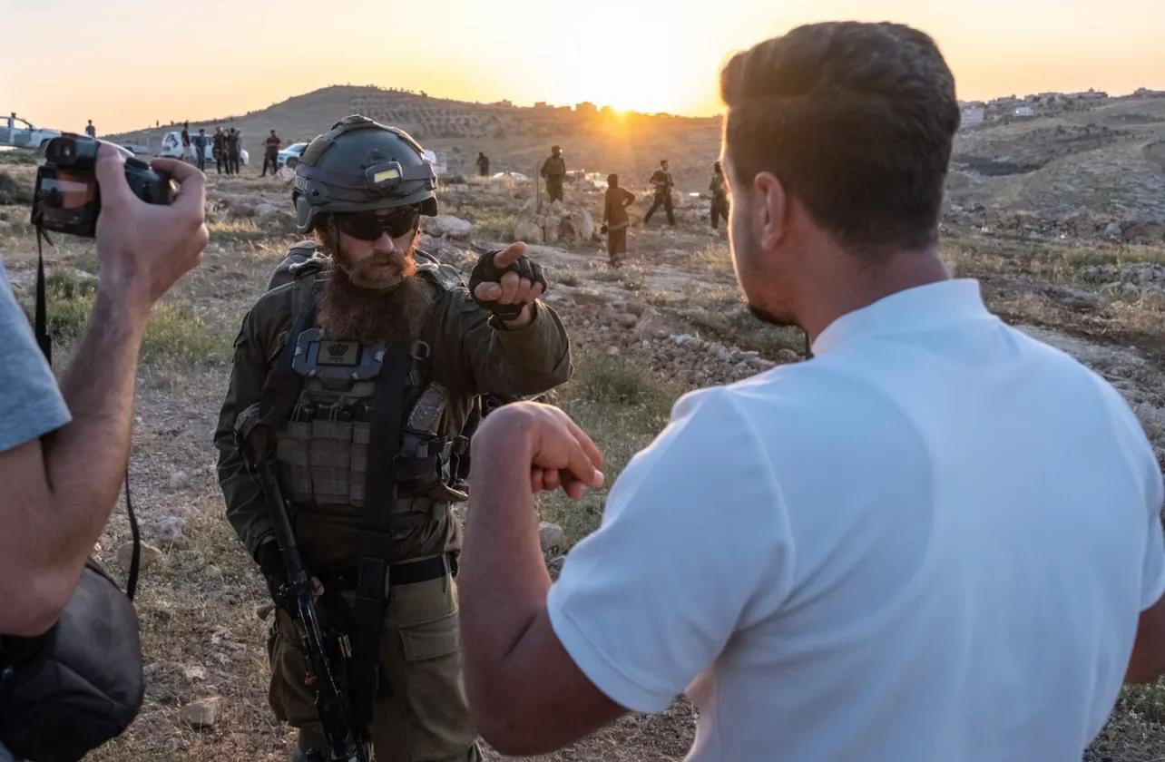 Palestinians are regularly removed from their land by Israeli troops, who say it belongs to the army. Mohammad Hesham Huraini is pictured (R)