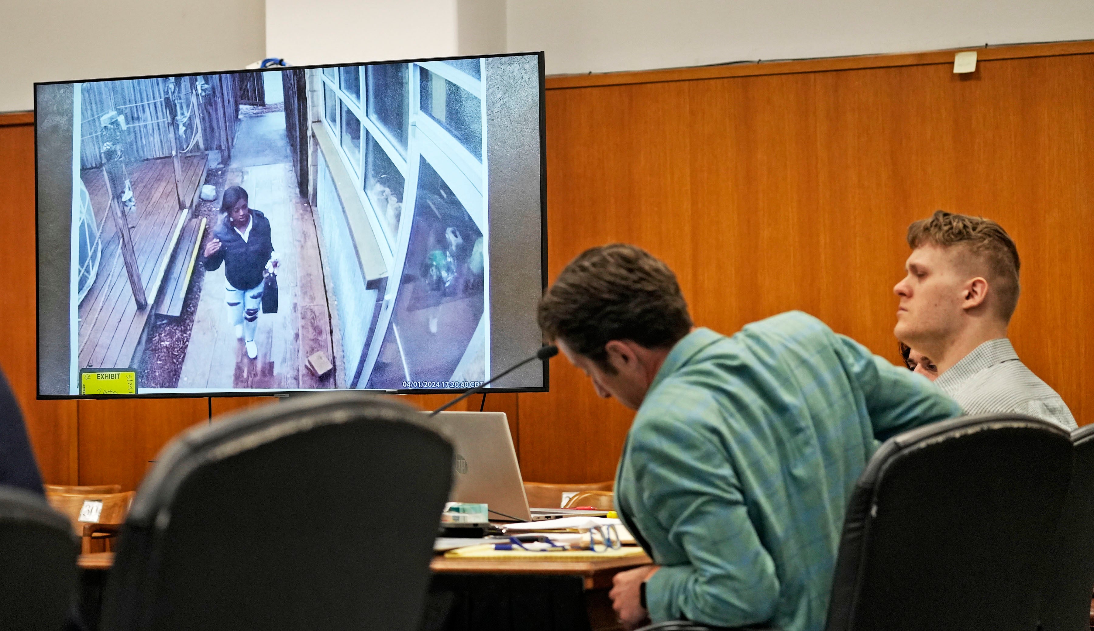 A still image from a video shows Sade Robinson, left, arriving at the Twisted Fisherman restaurant where she met Maxwell Anderson, seated in court on the right, with his defense attorney Anthony Cotton, left, in Milwaukee County Circuit on Monday