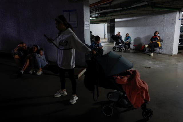 <p>Residents take shelter inside an underground parking during Russian drone and missile strikes, amid Russia's attack on Ukraine, in Kyiv, Ukraine</p>