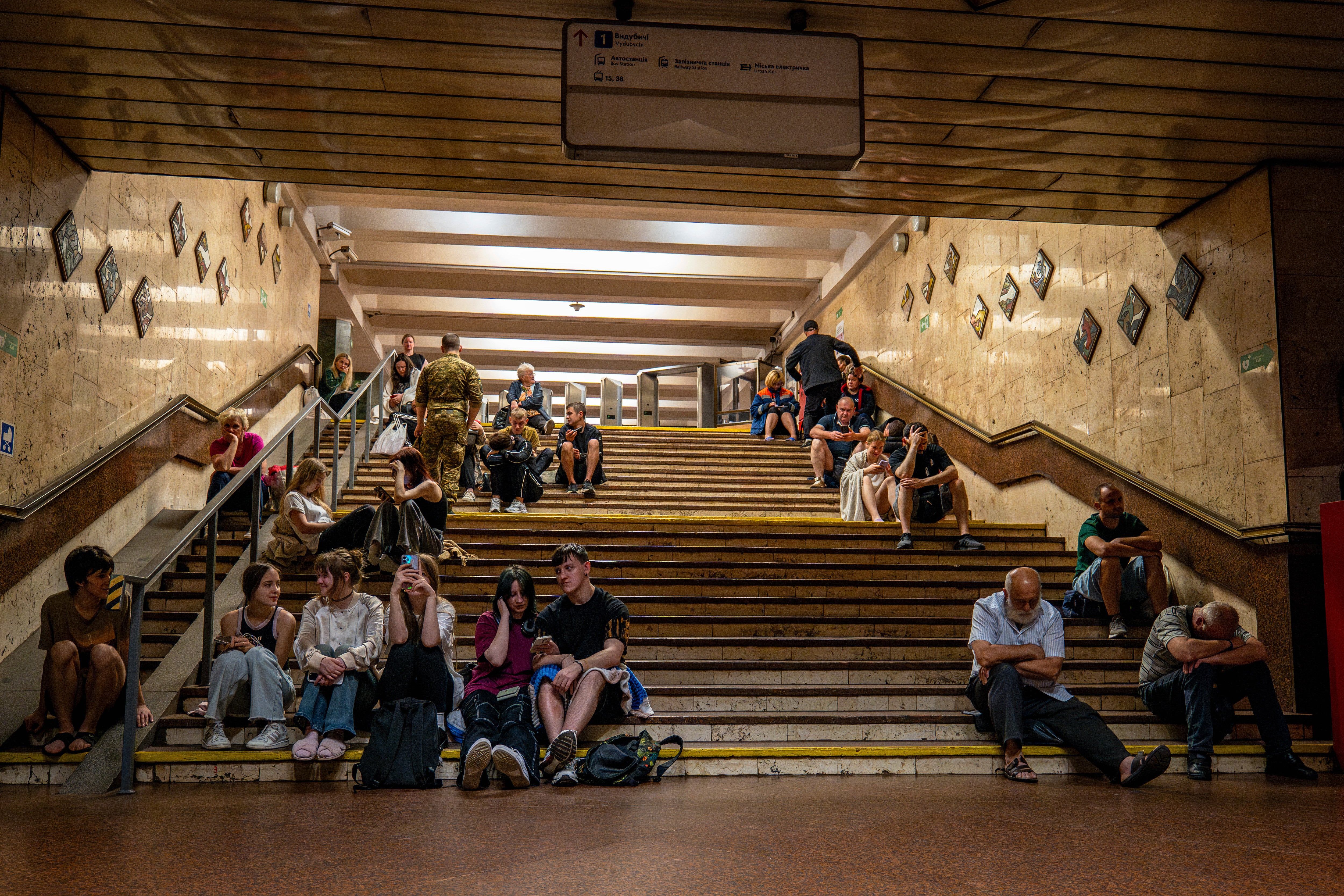 People rest in a metro station being used as a bomb shelter, during a Russian drones attack in Kyiv
