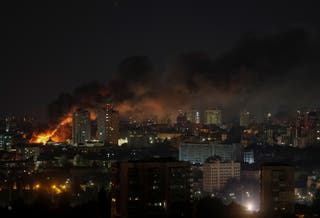 Fire and smoke rise after a Russian drone strike on Kyiv