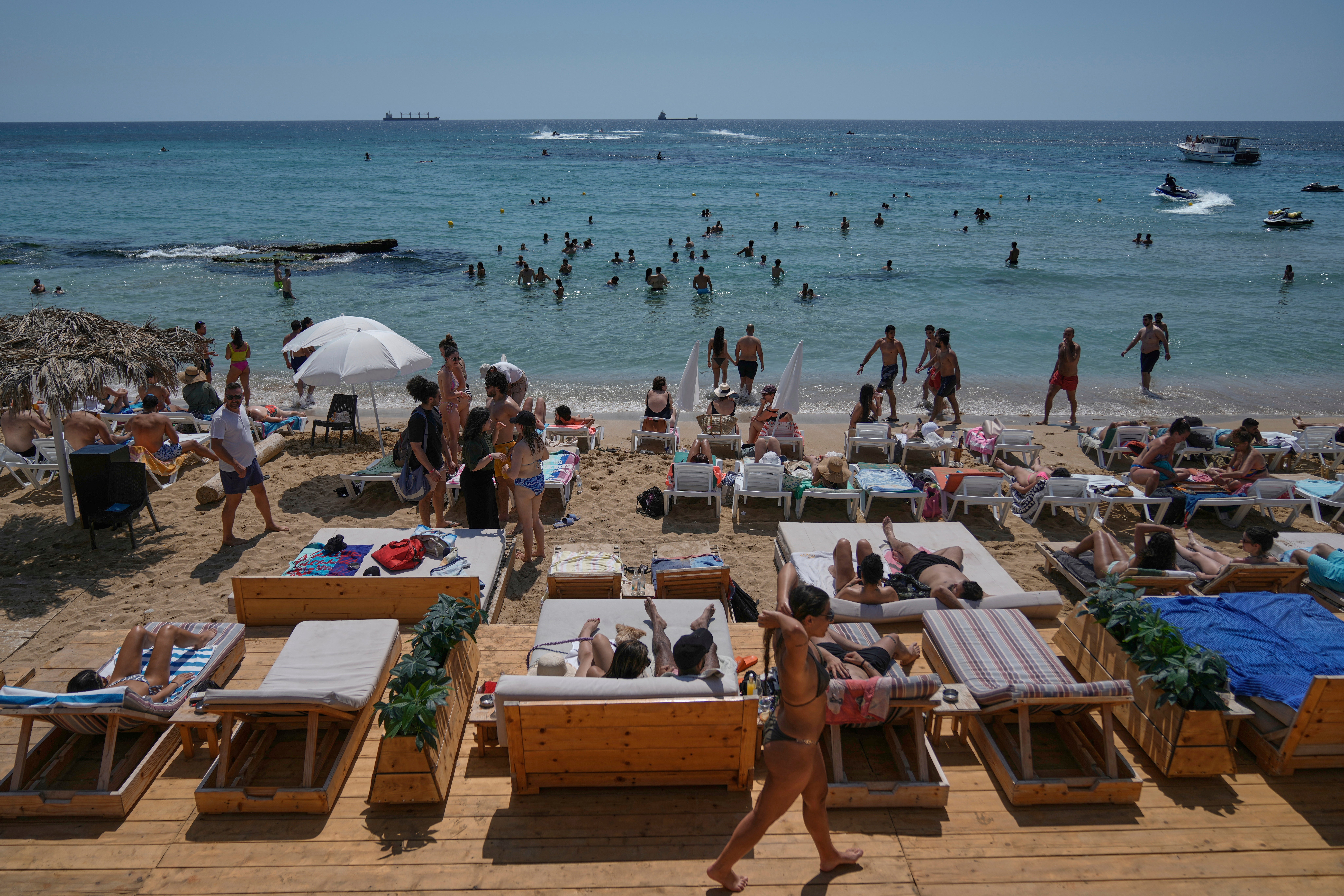 People sunbathe on the beach along the Mediterranean Sea in Batroun, northern Lebanon, May 31, 2025. (AP Photo/Bilal Hussein)