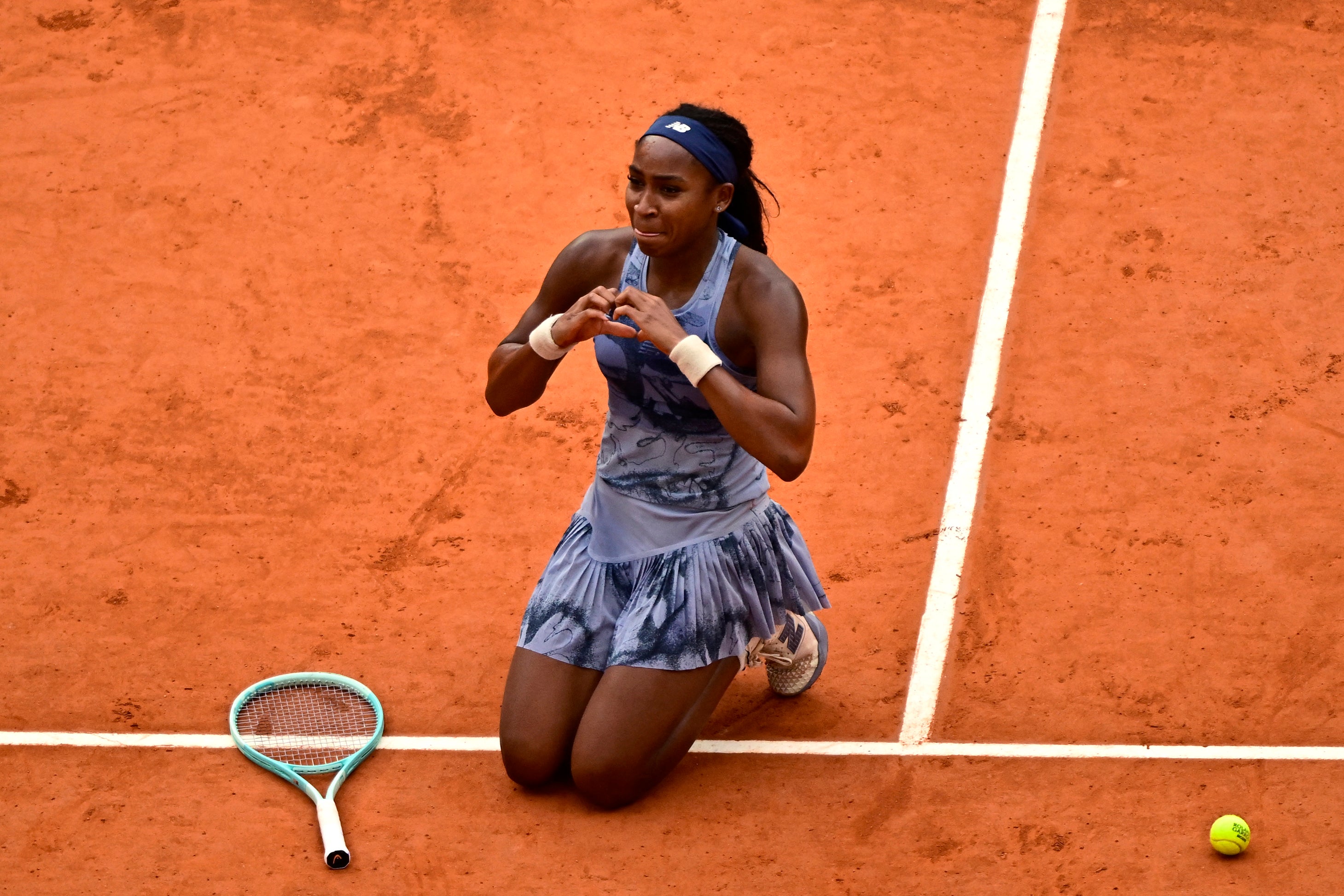 Coco Gauff gestures to her mother in the stands