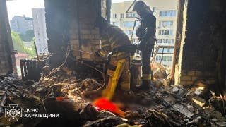 Rescuers working at the site of an airstrike in Kharkiv