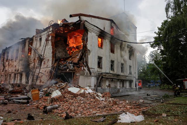 <p>Firefighters work at the site of a building hit by a Russian drone strike, amid Russia's attack on Ukraine, in Kharkiv</p>