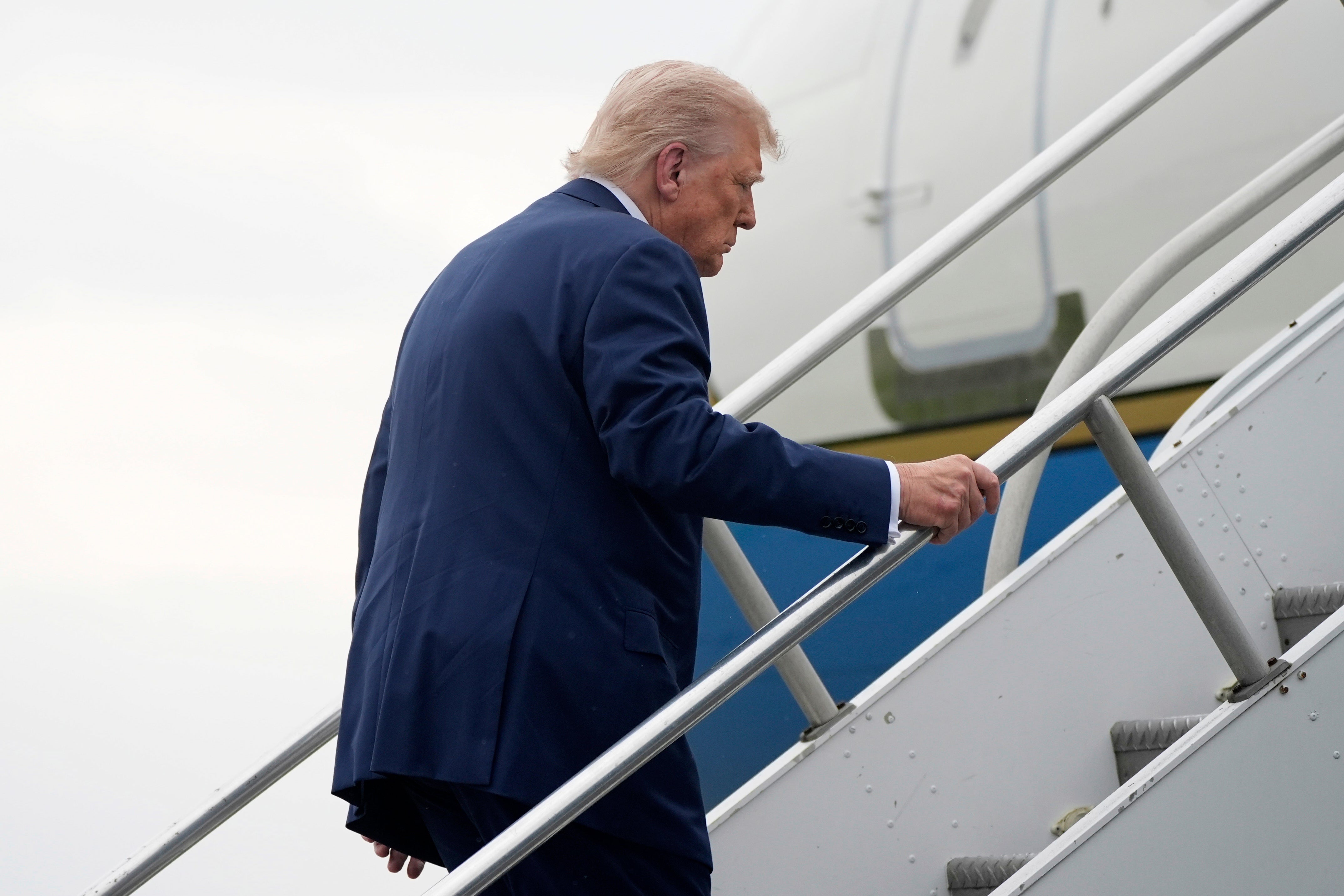 Trump stumbled as he made his way up the stairs of Air Force One on Sunday