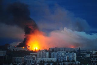 Fire and smoke rise from the site where a Russian missile struck a residential area in Kharkiv