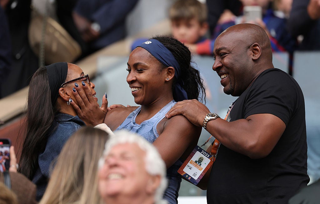 Coco Gauff embraces her mother Candi Gauff and father Corey Gauff after winning the French Open